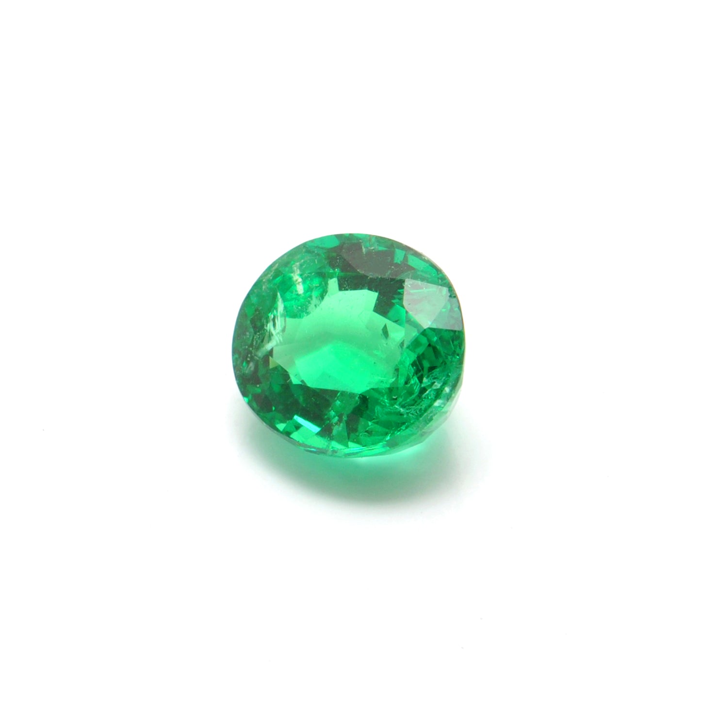 Close-up of a Kanika Creations natural Zambian emerald gemstone, 3.05 carats, oval faceted cut, 8.5x9.5mm, showcasing rich green color and stunning clarity.