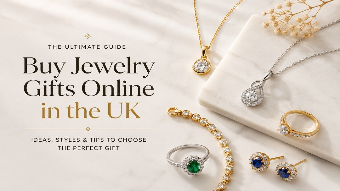 Gold, sterling silver, and gemstone jewelry arranged on a marble surface for a jewelry gift buying guide.