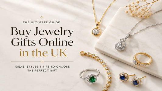 Gold, sterling silver, and gemstone jewelry arranged on a marble surface for a jewelry gift buying guide.