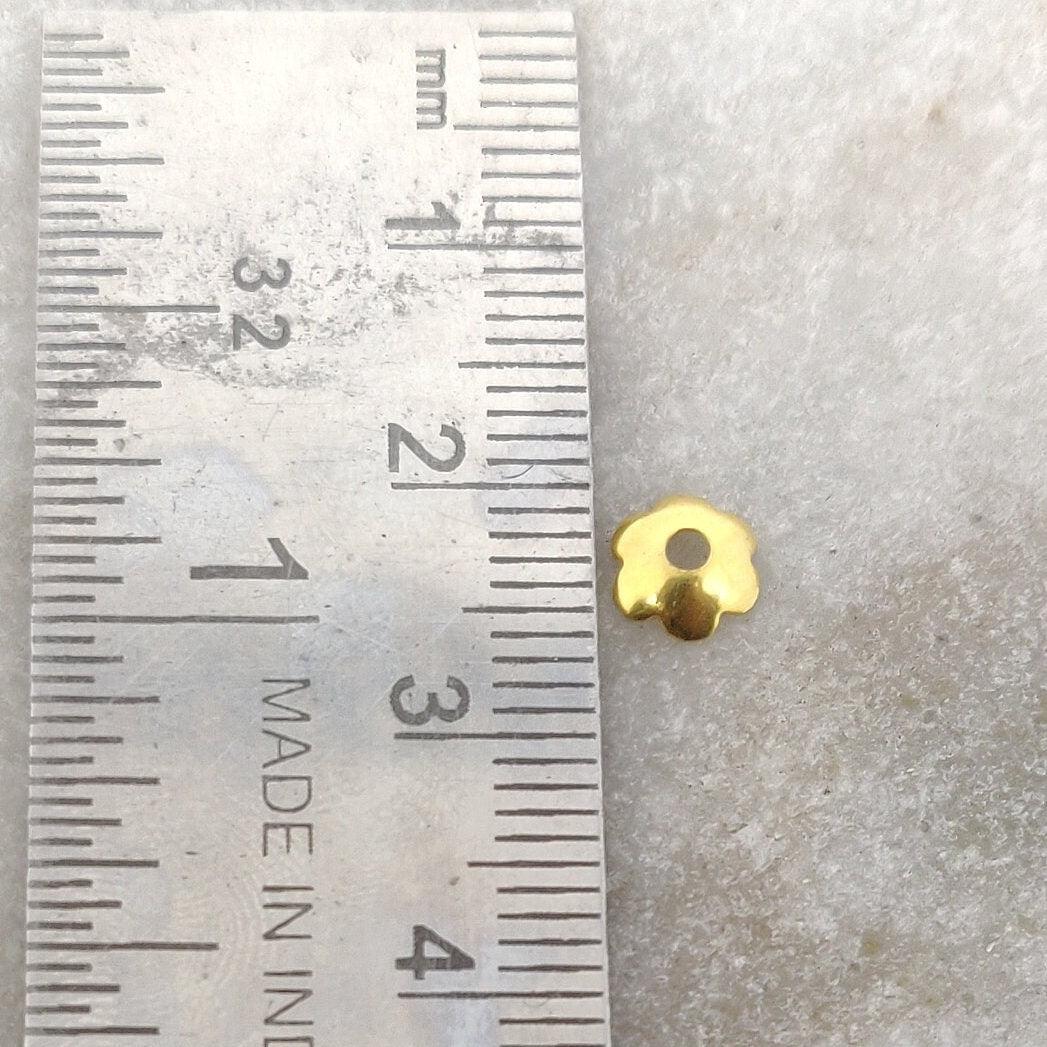18K gold floral plain bead caps 2x6mm styled on delicate necklace