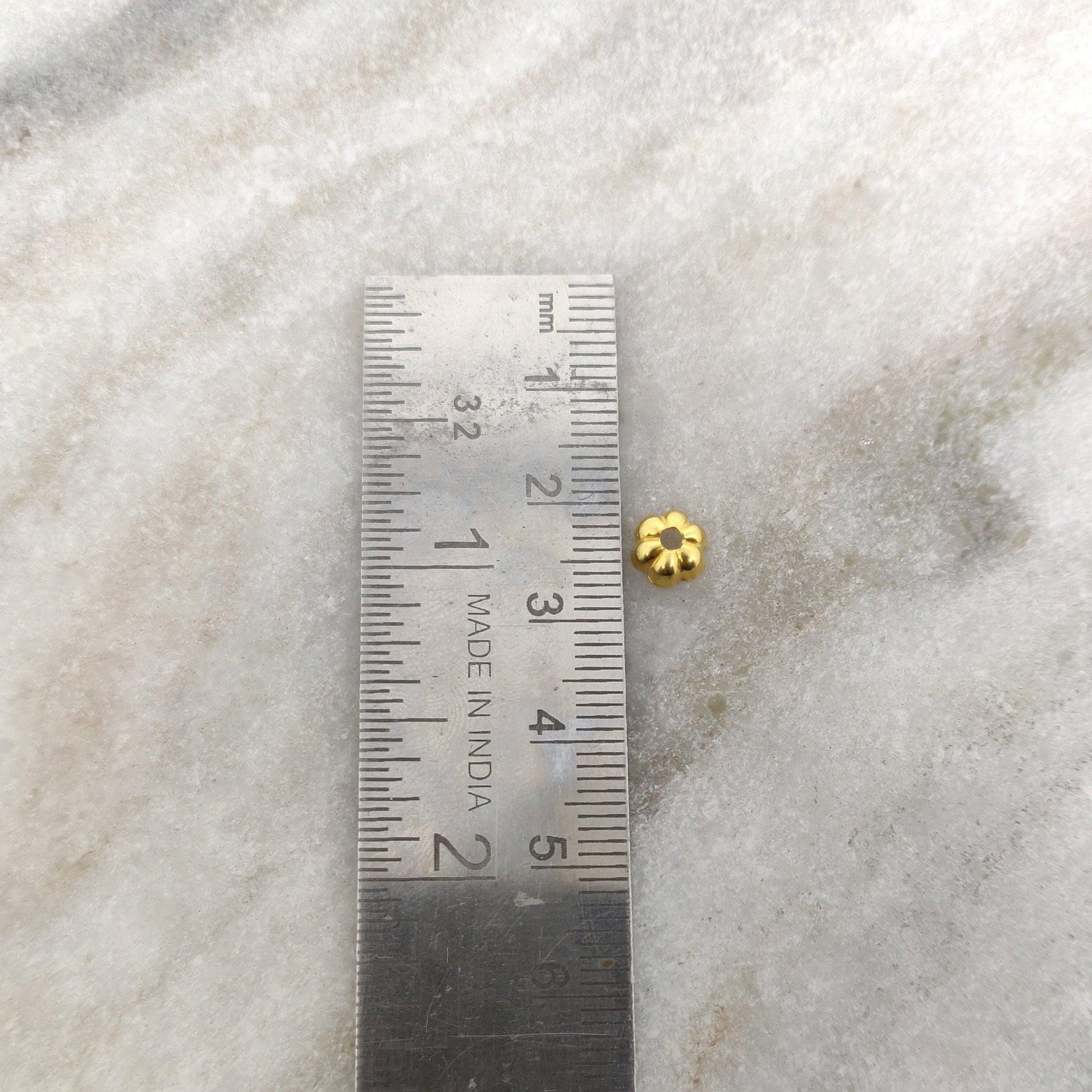 18K gold floral bead caps 2x6mm styled on delicate jewelry