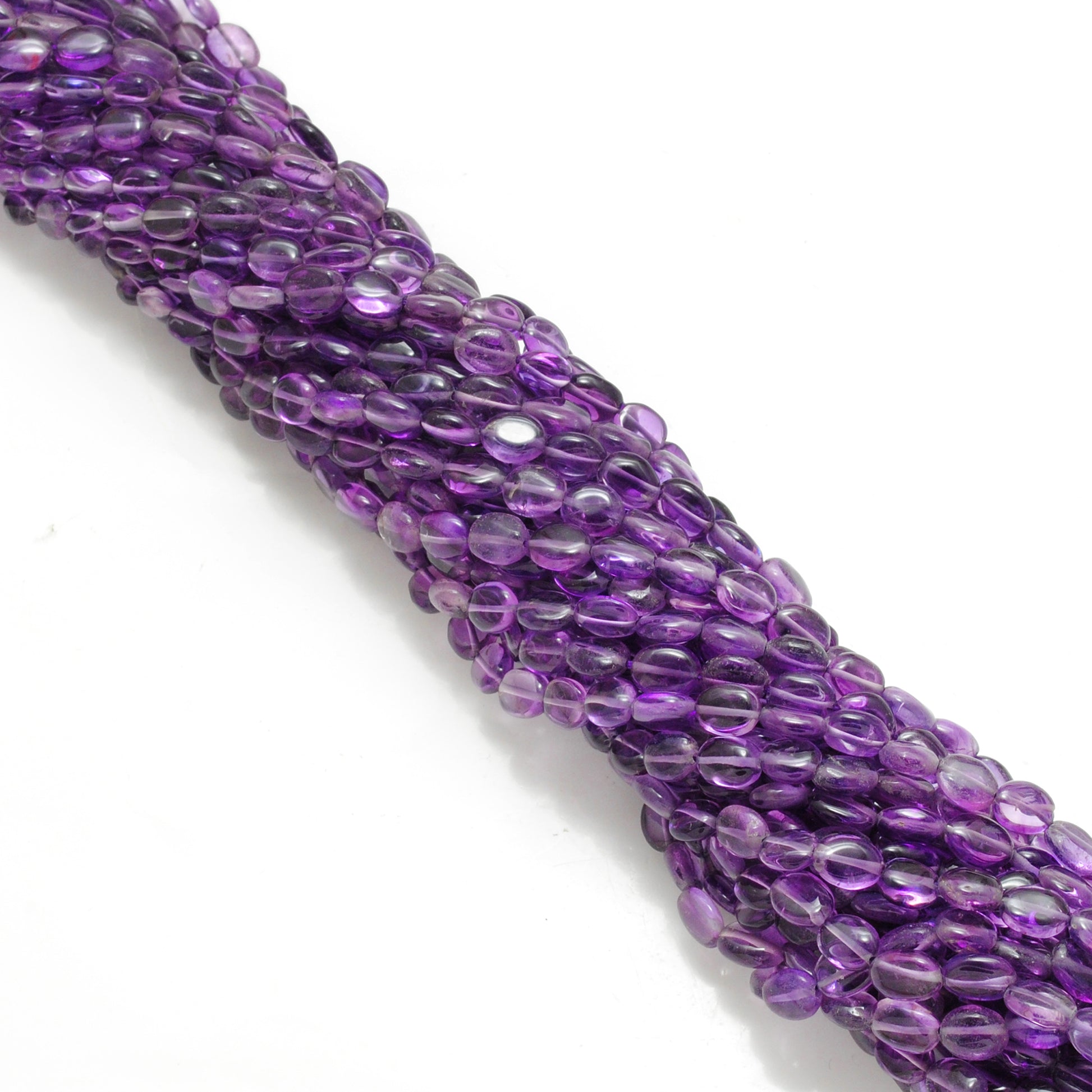Amethyst oval beads scattered loose - color variation view