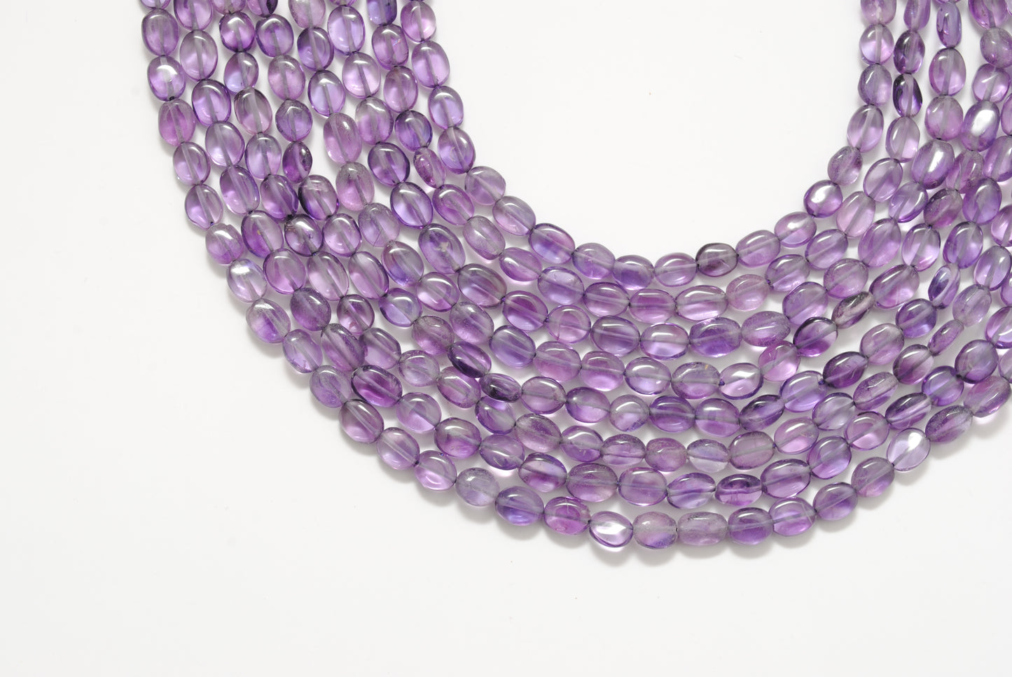 Amethyst oval beads center drilled - close-up purple mixed sizes
