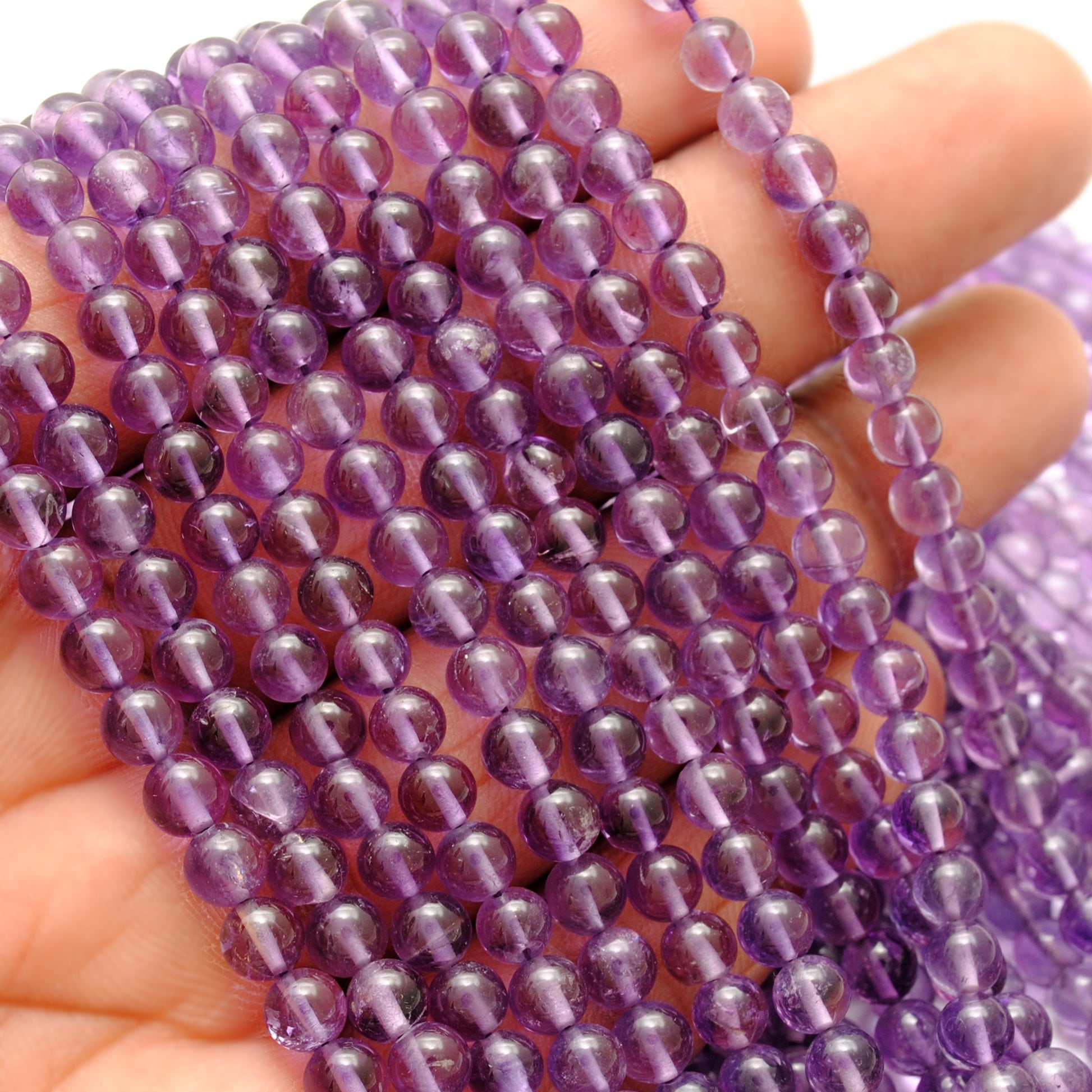 Natural amethyst round beads 4mm - scale reference