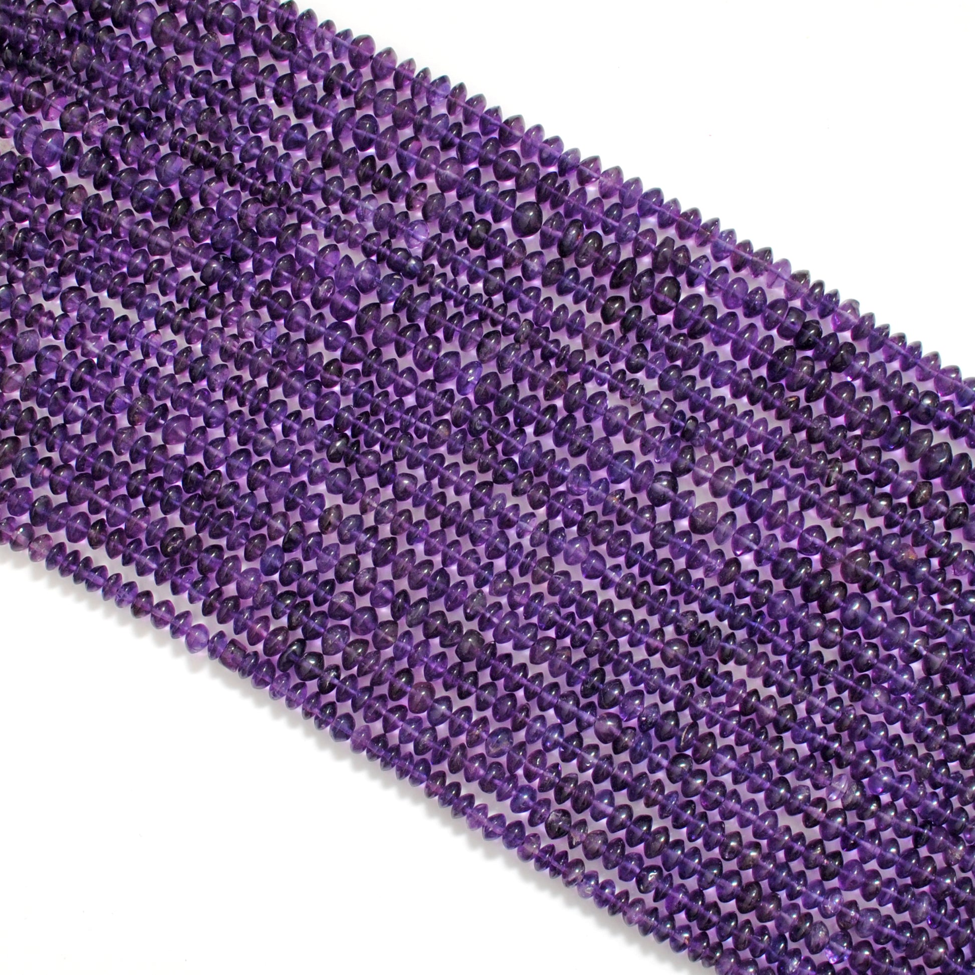 Amethyst smooth button beads - close-up flat disc polished purple
