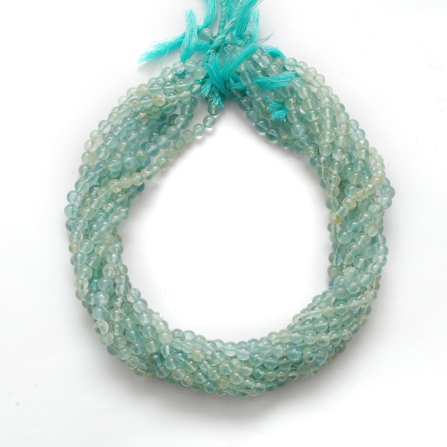 Aquamarine 5-5.5mm round beads scattered loose view