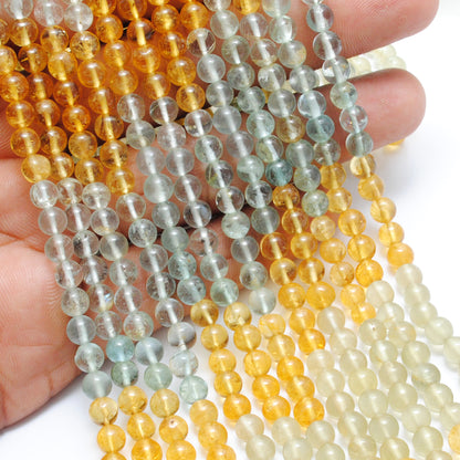 Aquamarine 5mm round beads scattered loose - uniform size view