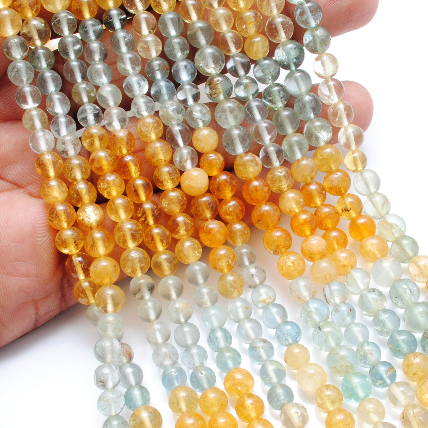 Aquamarine 6-7mm round beads scattered loose view