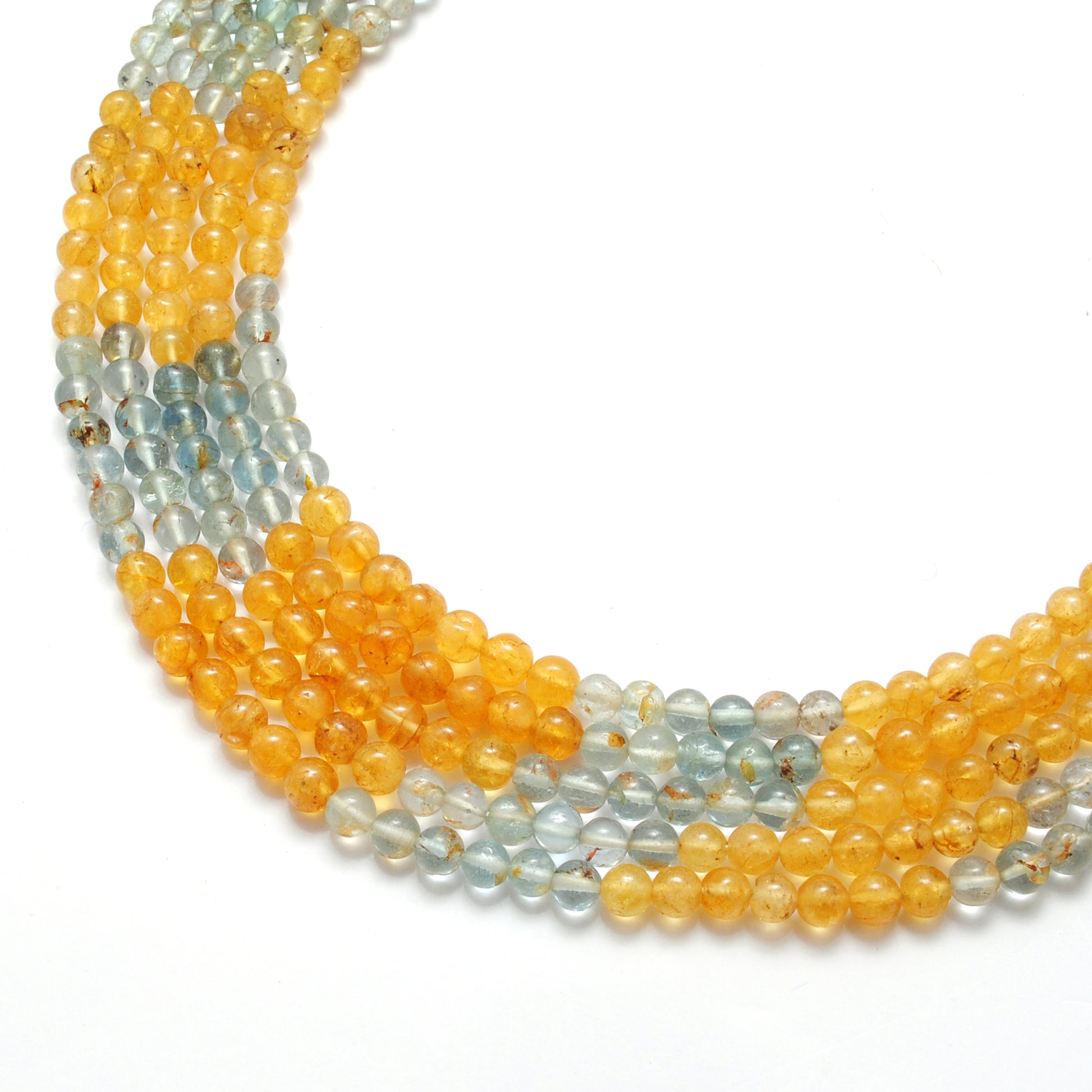 Aquamarine round beads scattered loose - blue-green range