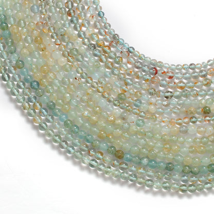 Aquamarine round beads scattered loose - natural size variation