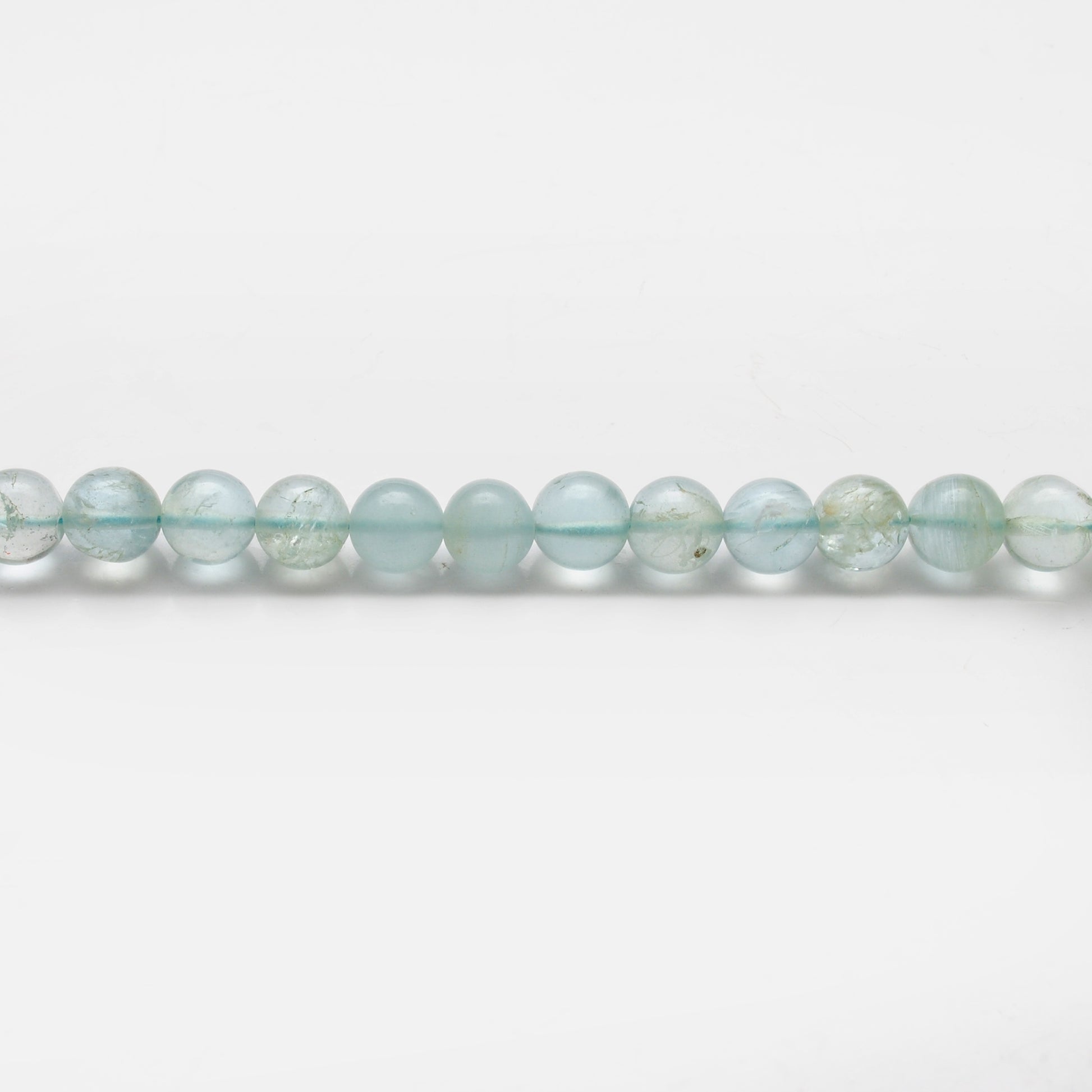 Aquamarine smooth beads 7-9mm strand - color comparison view