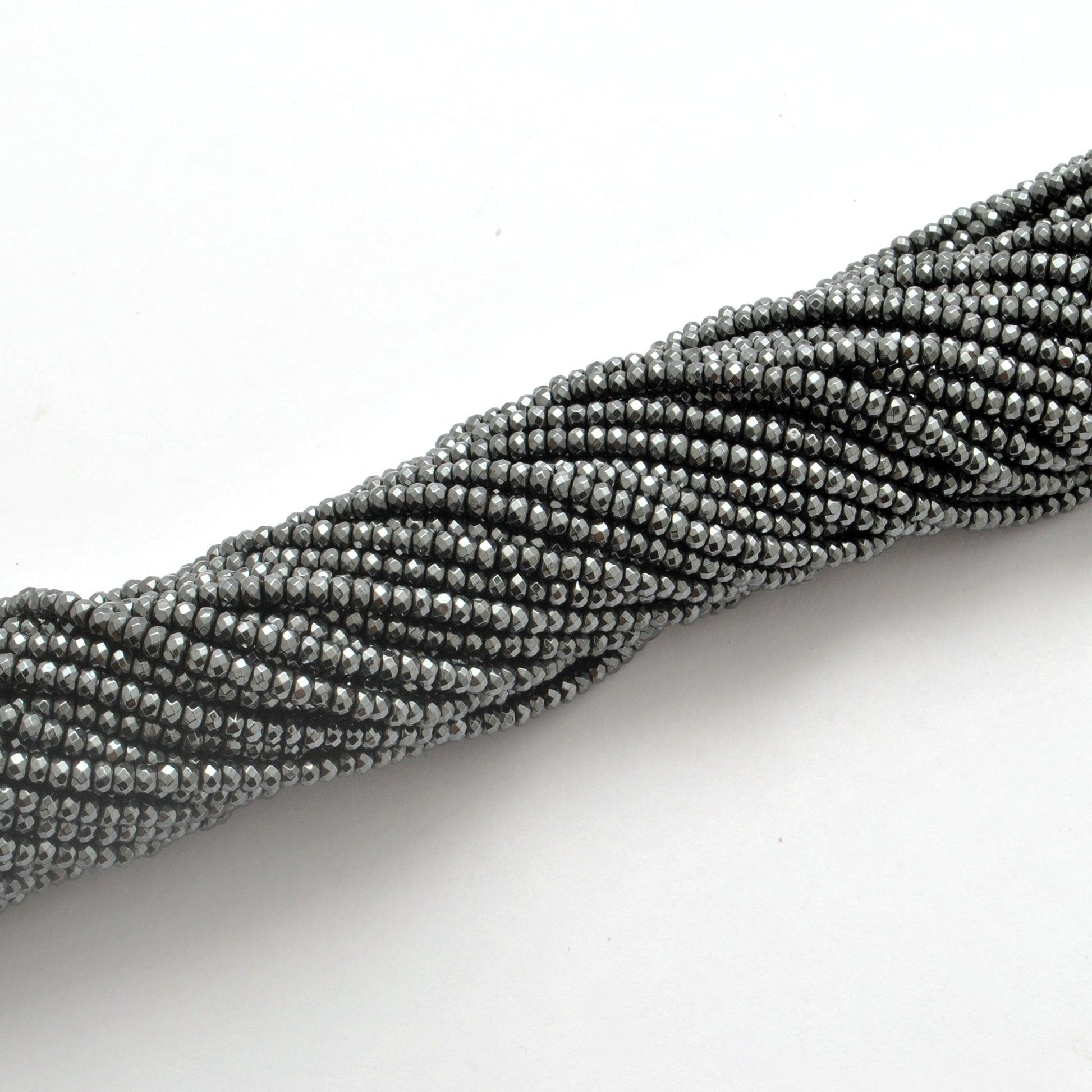 Black hematite faceted beads for jewelry making - scale reference