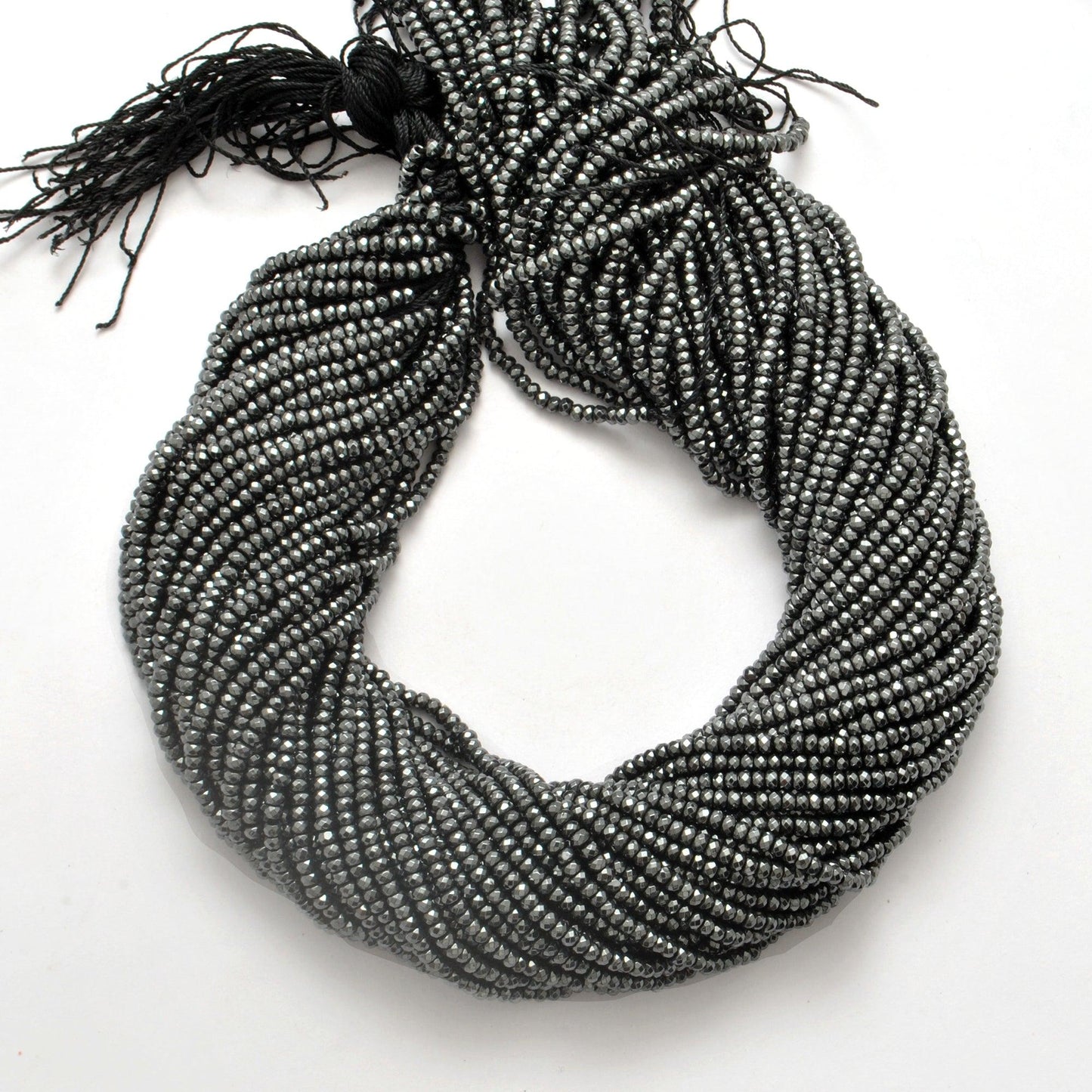 Black hematite rondelle beads strand - overhead flat lay dark view