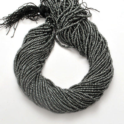 Black hematite rondelle beads strand - overhead flat lay dark view