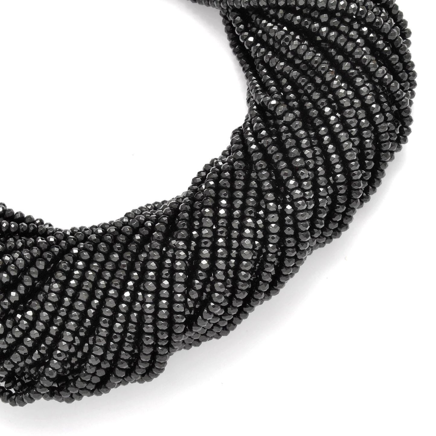 Black onyx faceted beads - side profile scattered loose beads