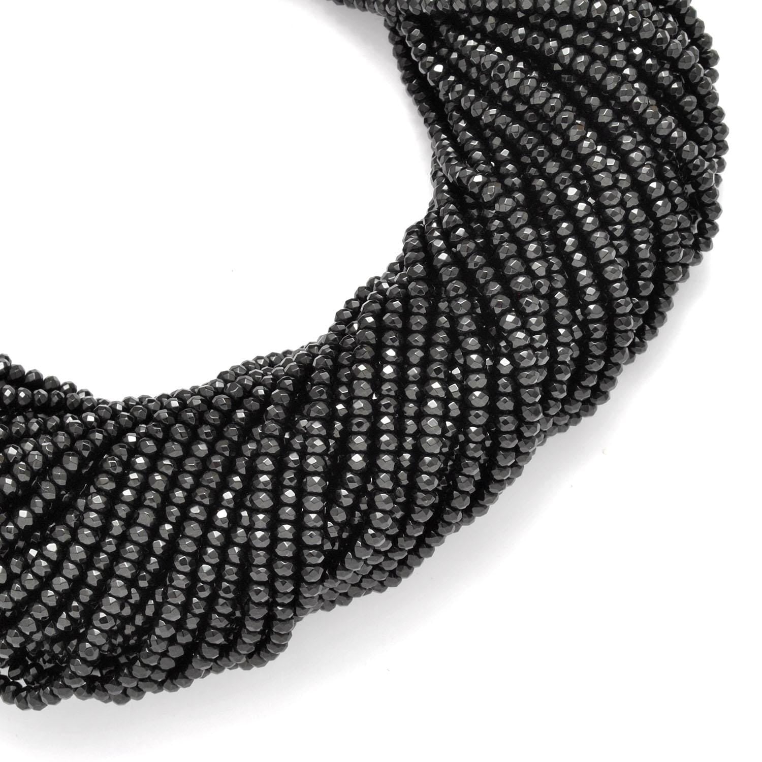 Black onyx faceted beads - side profile scattered loose beads