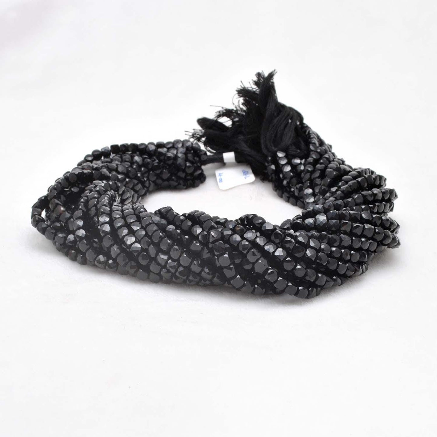 Black onyx faceted cube beads 4mm - close-up geometric dark detail
