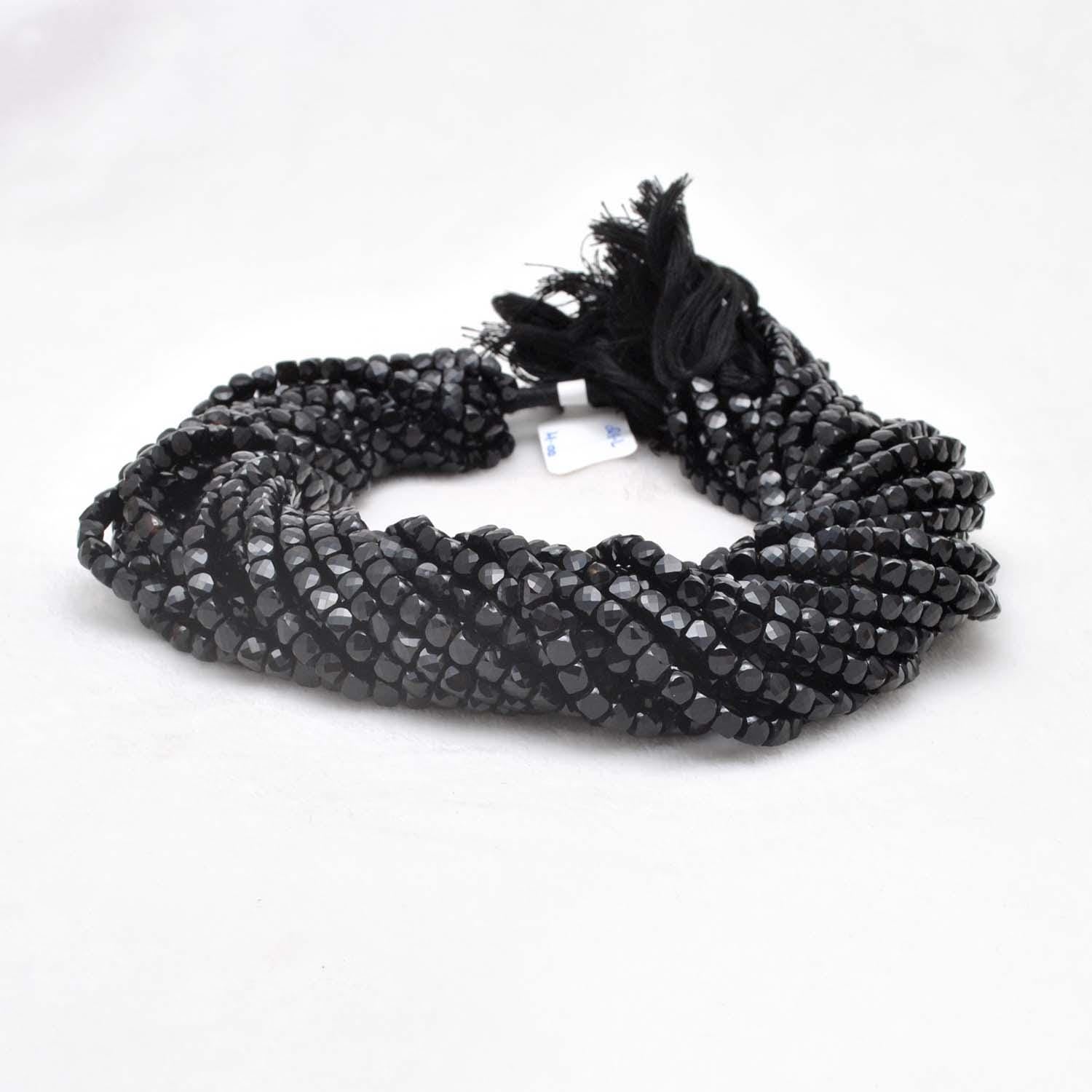 Black onyx faceted cube beads 4mm - close-up geometric dark detail