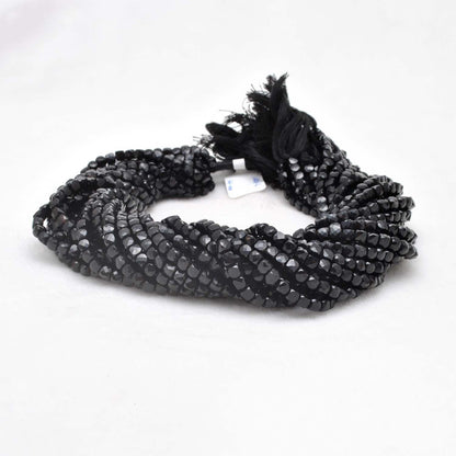 Black onyx faceted cube beads 4mm - close-up geometric dark detail