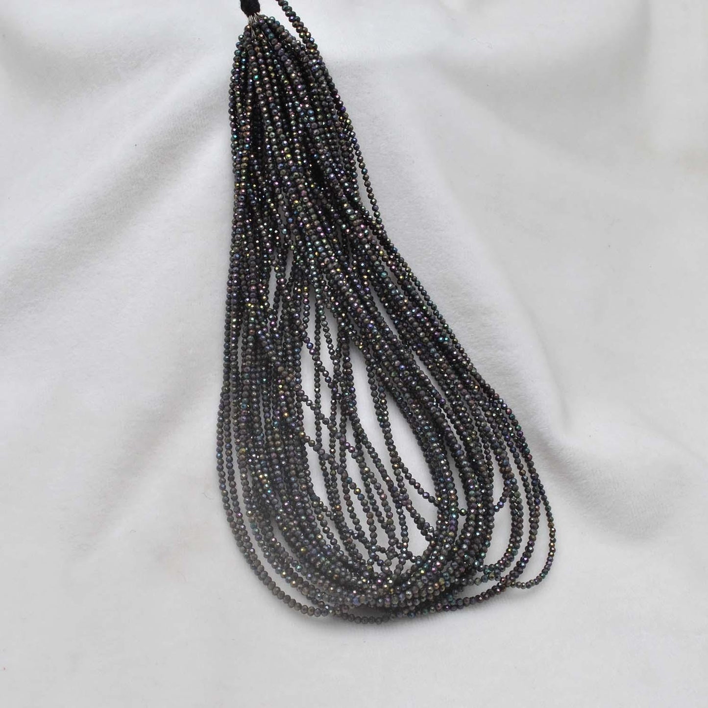 Black spinel coated beads - close-up brilliant faceted detail