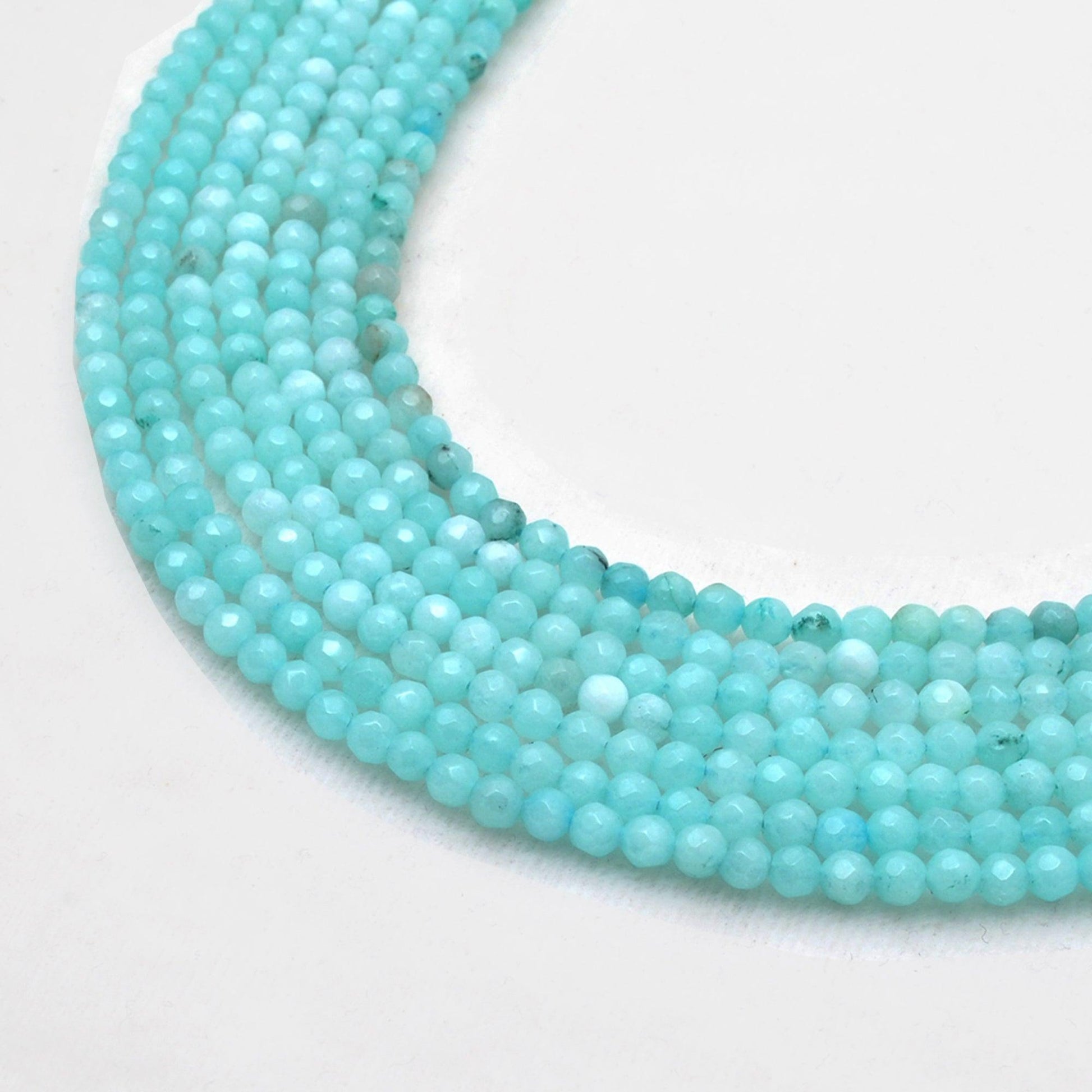Blue aqua quartz faceted round beads 15 inch strand - front view vivid aqua