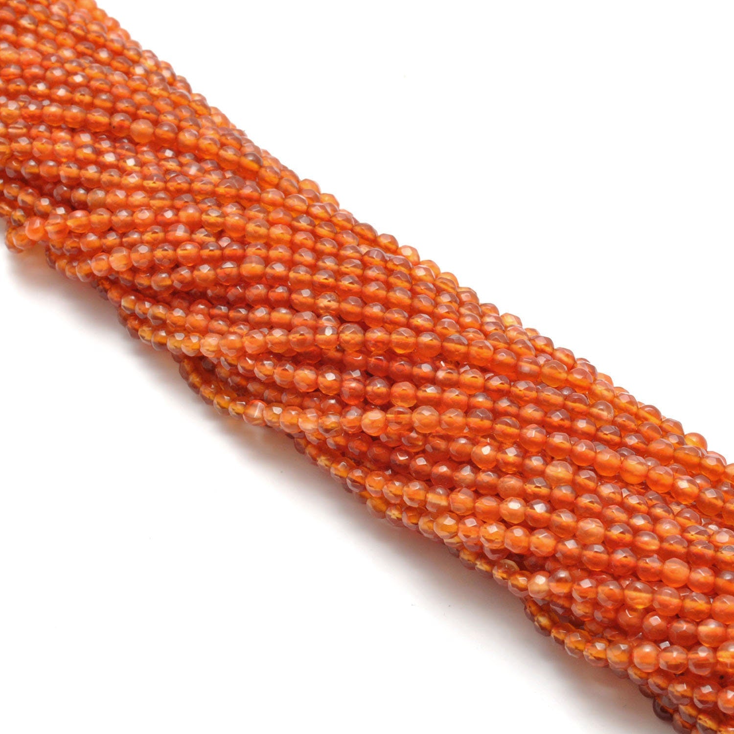 Carnelian round faceted beads - side profile scattered loose beads