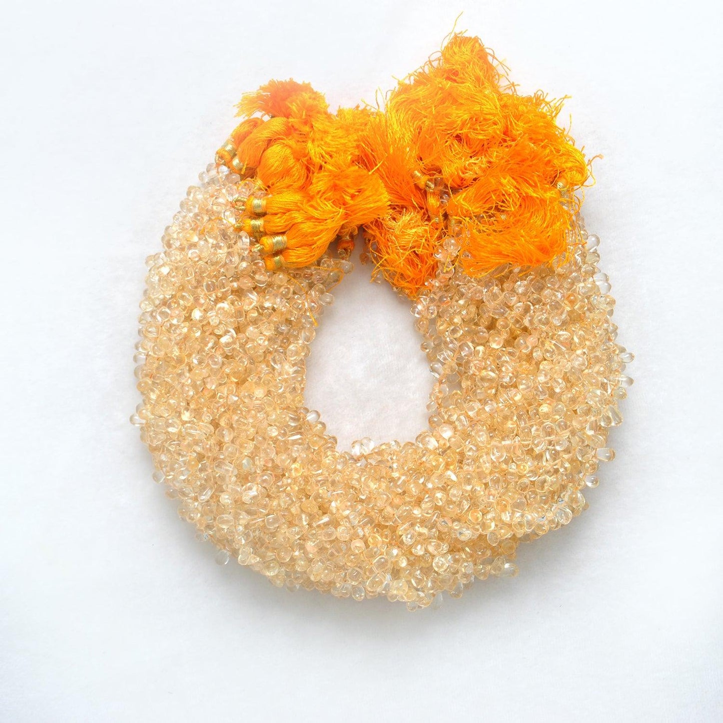 Citrine teardrop beads smooth - close-up golden yellow shape