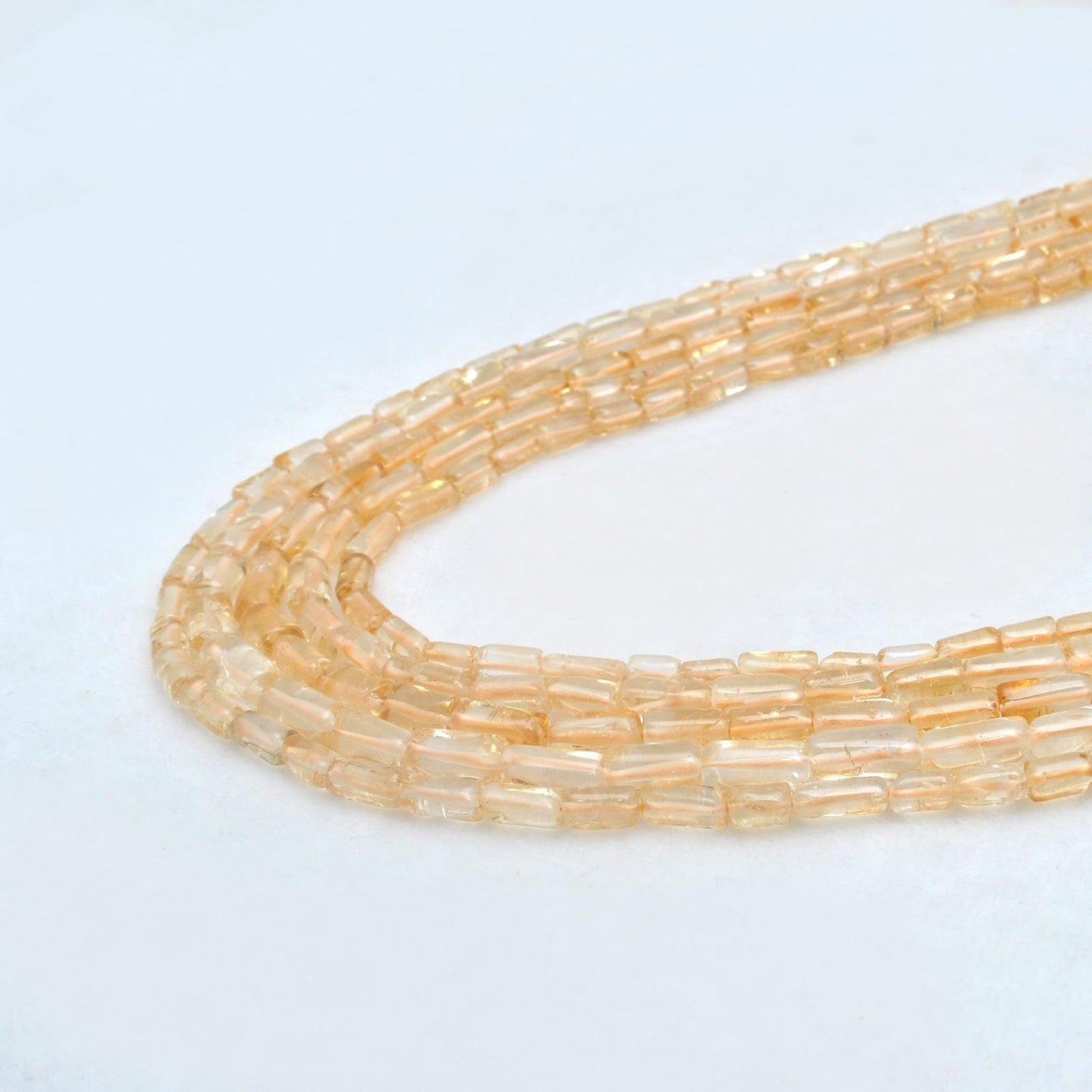 Citrine tube beads scattered loose - golden warm tones view