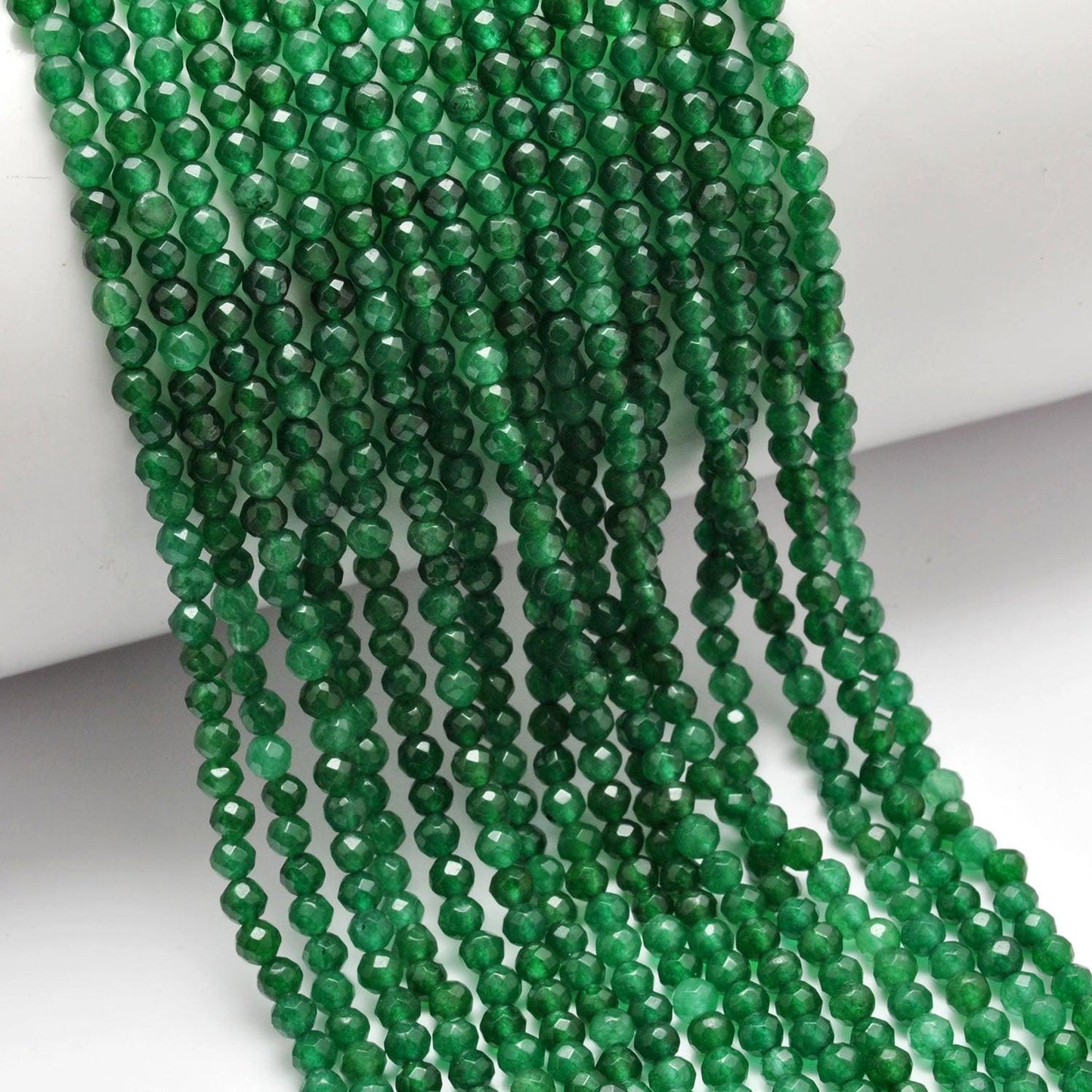 Green quartz round beads - close-up vivid green faceted detail