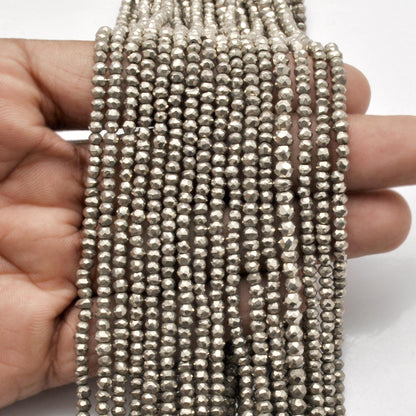 Grey pyrite faceted rondelle strand - overhead flat lay metallic