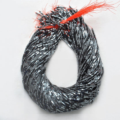 Hematite square gemstone beads strand - overhead flat lay dark