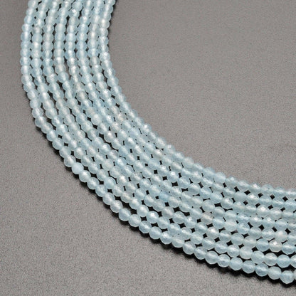 Light blue quartz faceted round beads 13.5 inch strand - front view pale blue