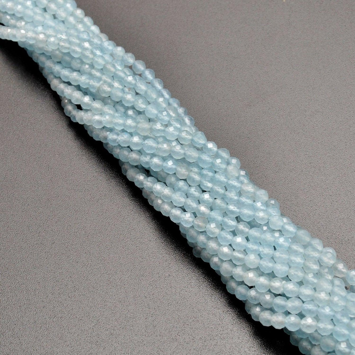 Light blue quartz round beads - side profile delicate pale blue
