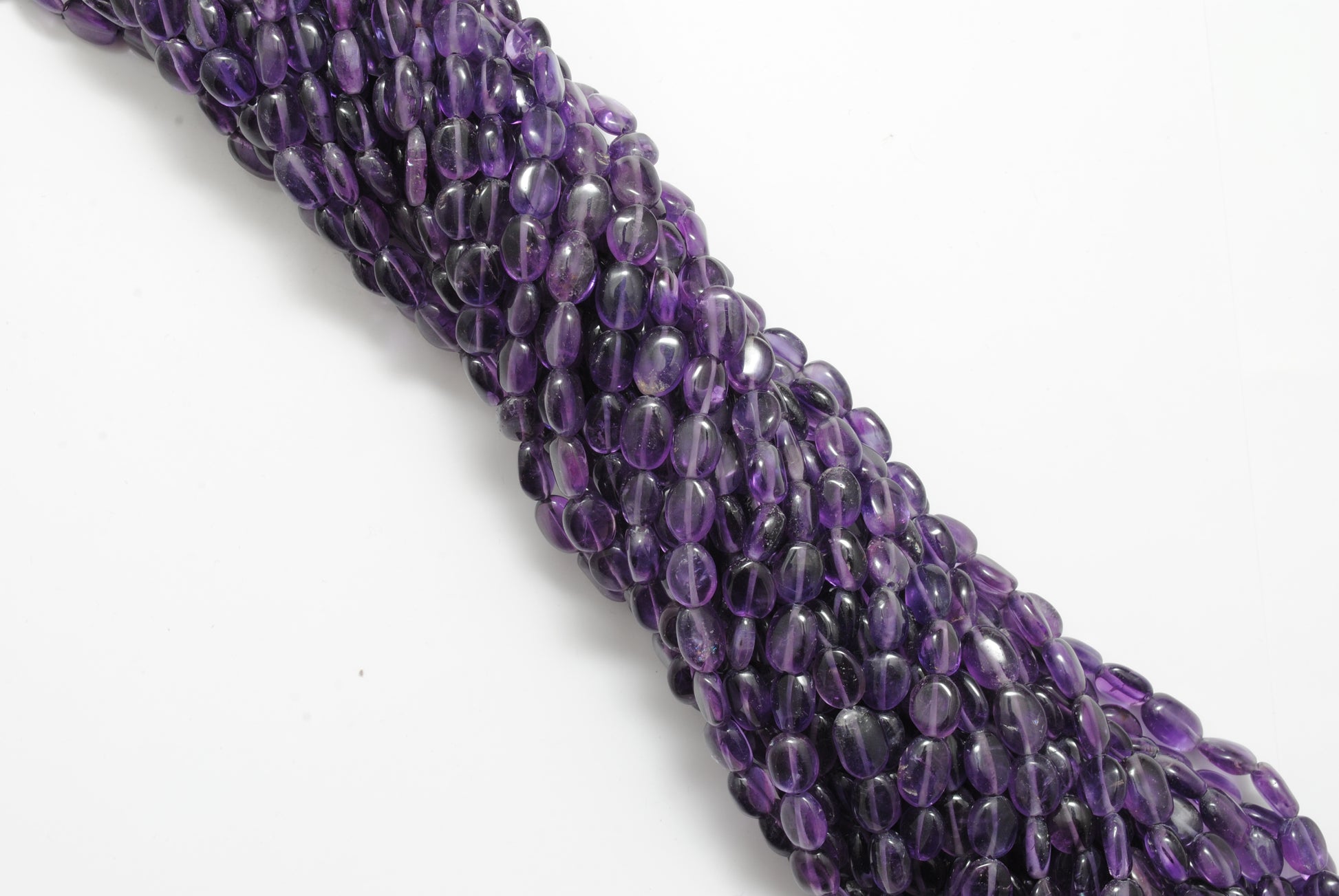 Natural amethyst oval beads 5x7mm strand 15 inch - overhead flat lay
