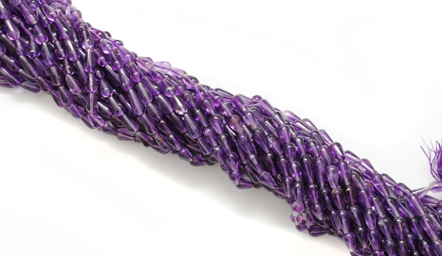 Natural amethyst drop beads 6x11mm - scale reference pendant