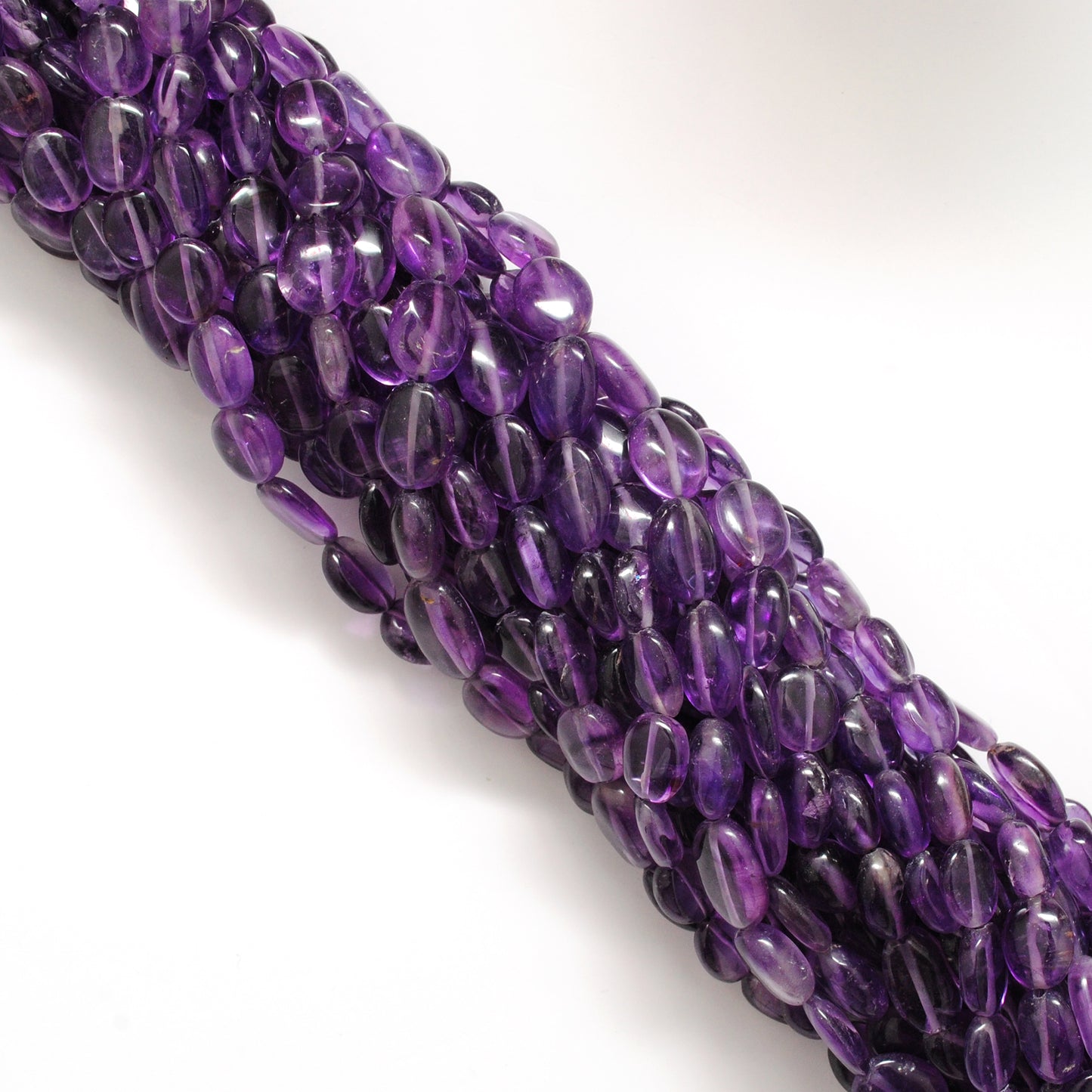 Natural amethyst long oval beads 15 inch - overhead flat lay