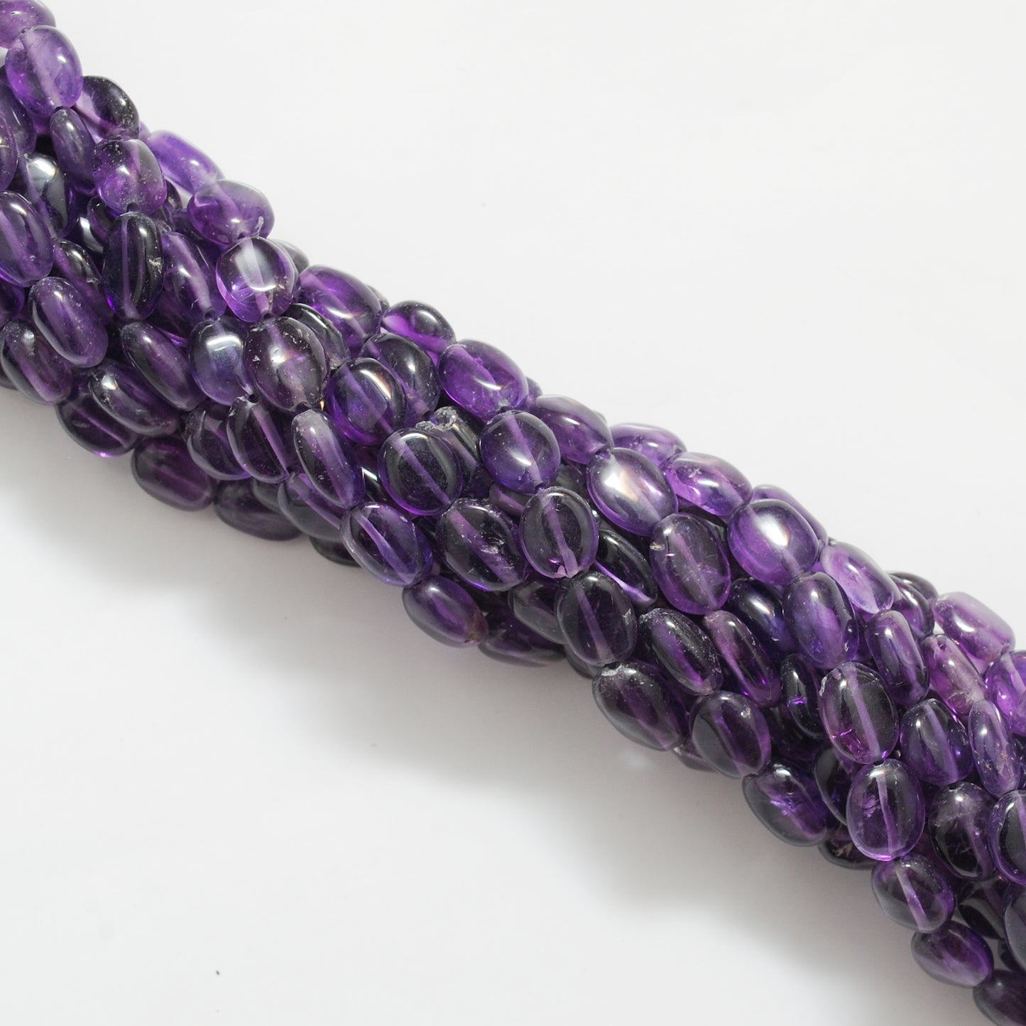 Natural amethyst oval beads 7x10mm strand - overhead flat lay