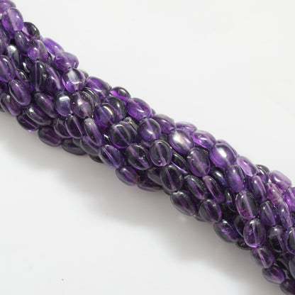 Natural amethyst oval beads 7x10mm strand - overhead flat lay