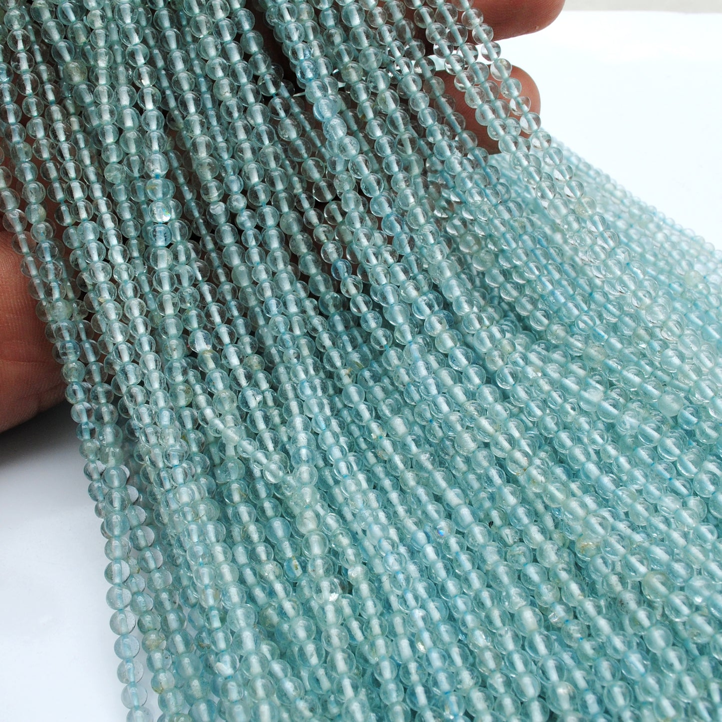 Natural aquamarine round beads - light through translucent gemstone