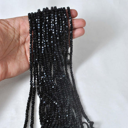 Natural black onyx cube beads strand - overhead flat lay
