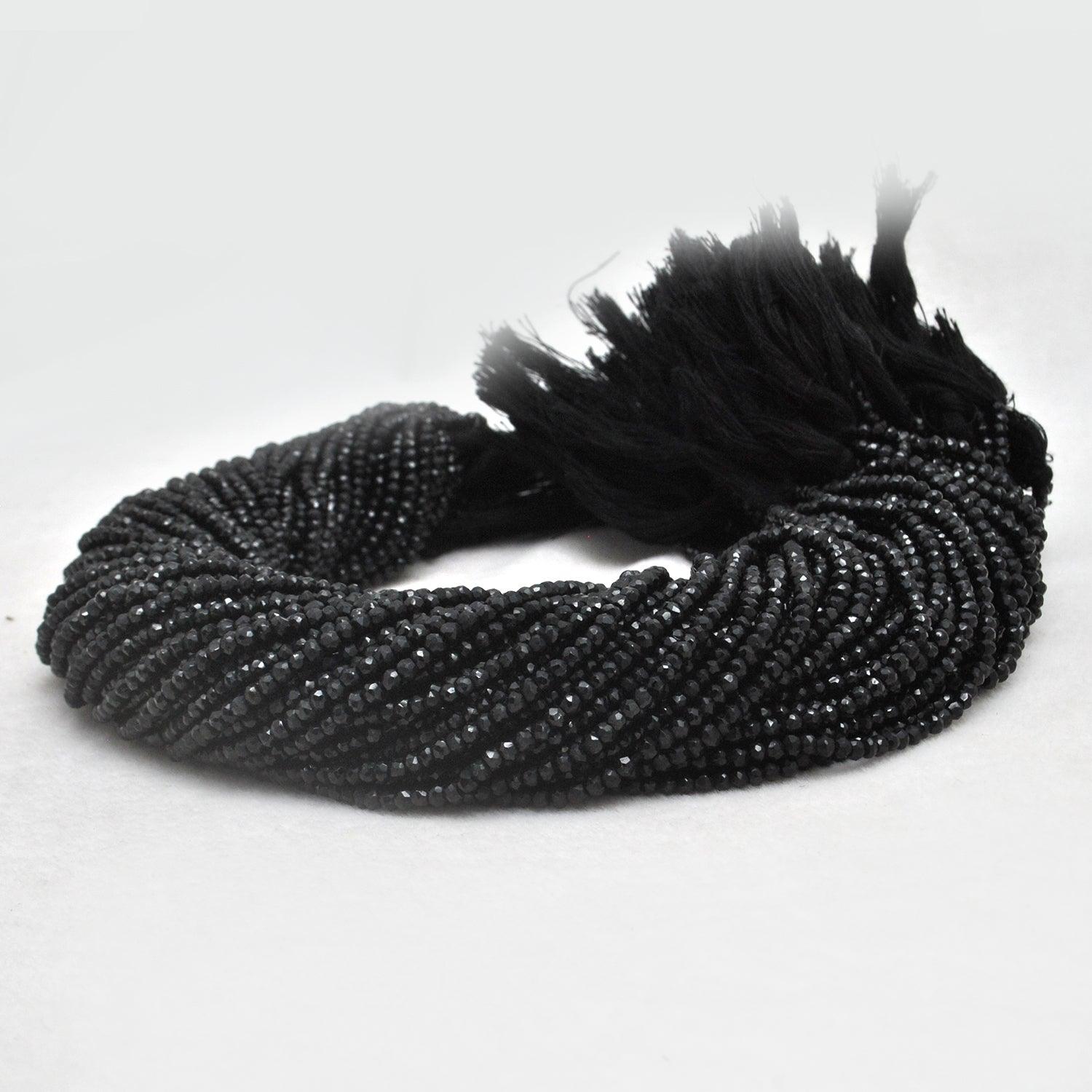Natural black spinel rondelle beads strand - overhead flat lay dark