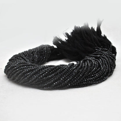 Natural black spinel rondelle beads strand - overhead flat lay dark