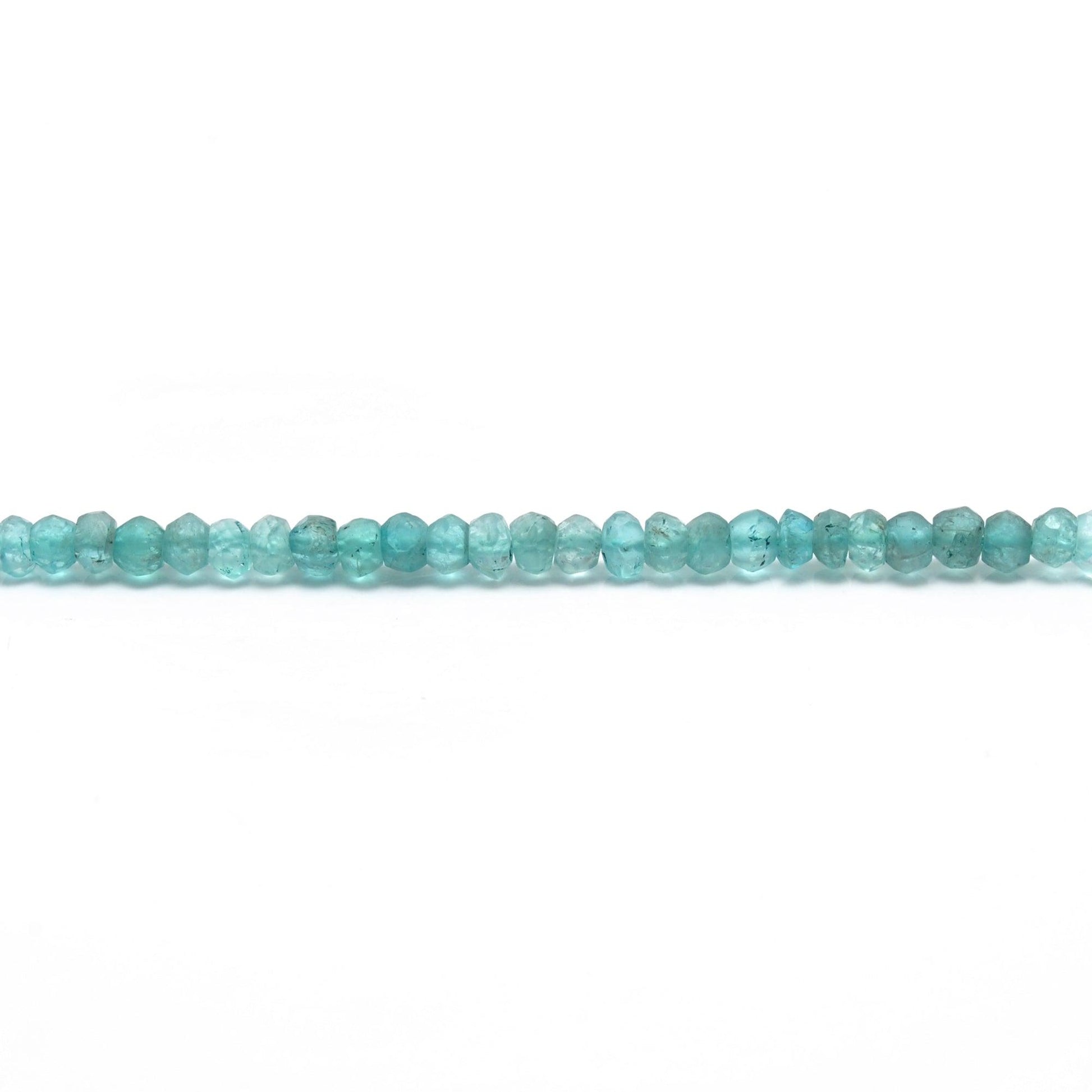 Natural blue apatite rondelle beads scattered loose - teal view