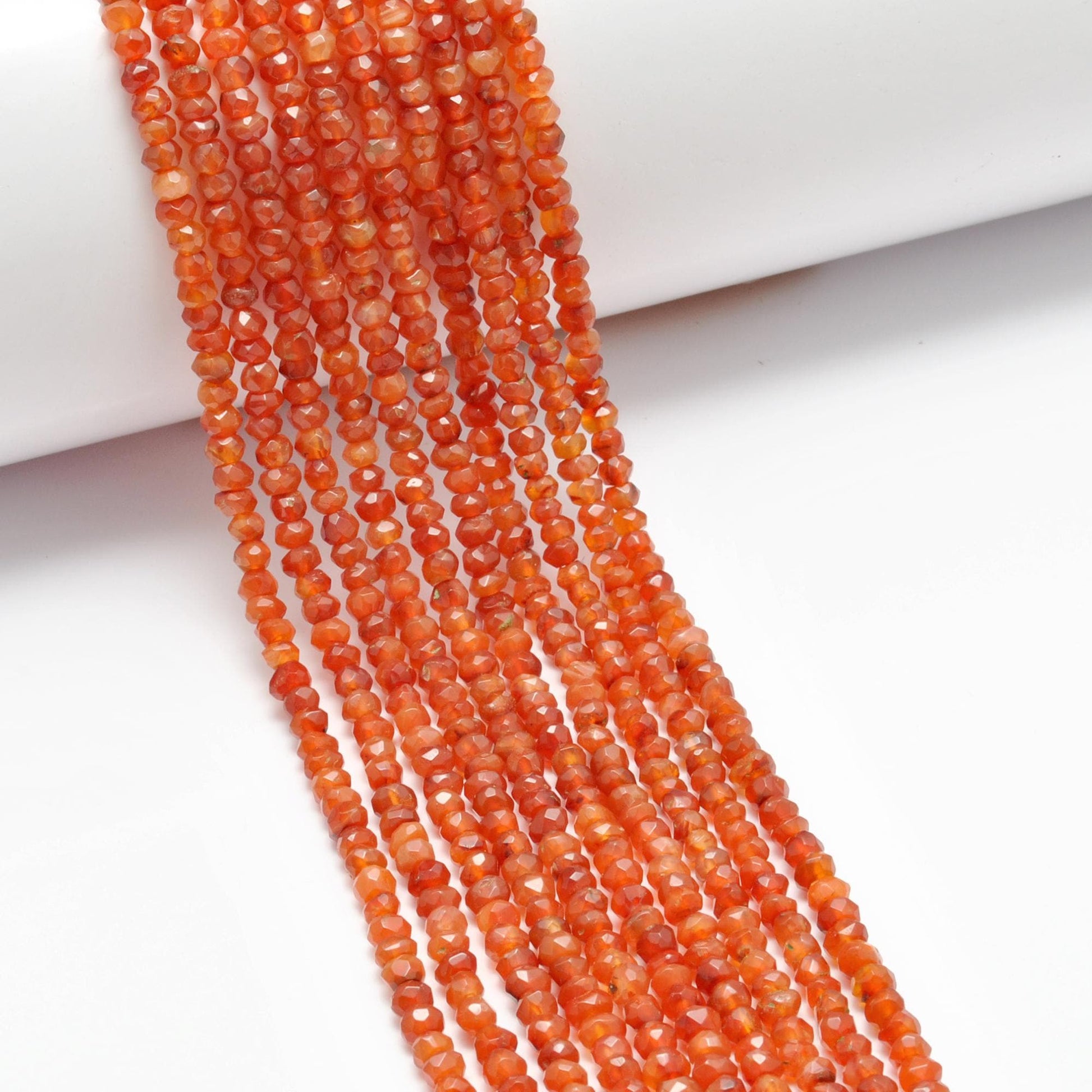 Natural carnelian rondelle beads 13 inch - overhead flat lay orange