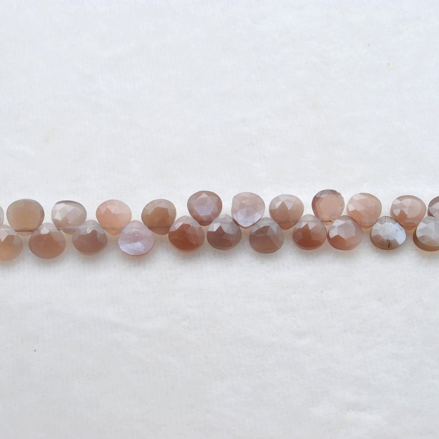 Natural chocolate moonstone heart beads - overhead flat lay warm