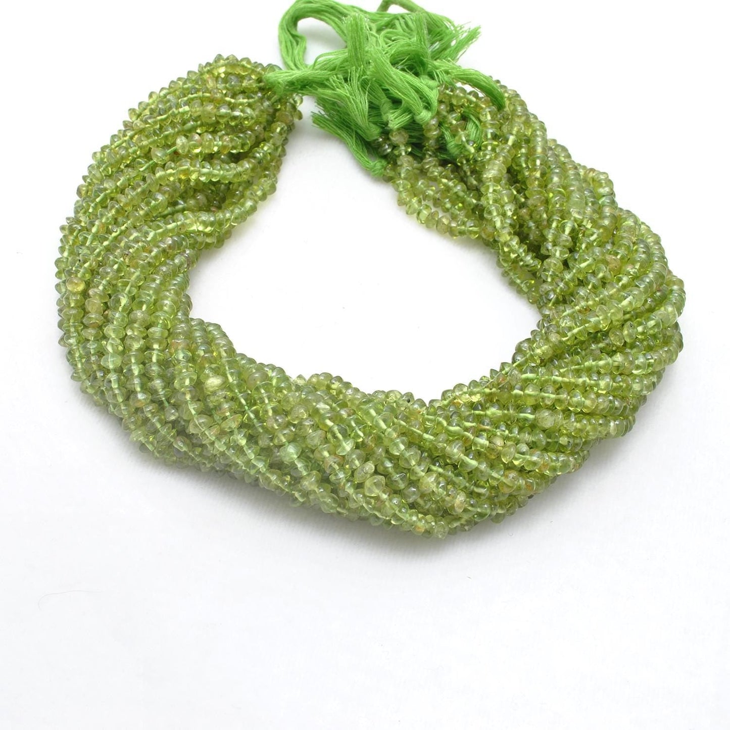 Natural peridot button beads scattered loose - lime olive range