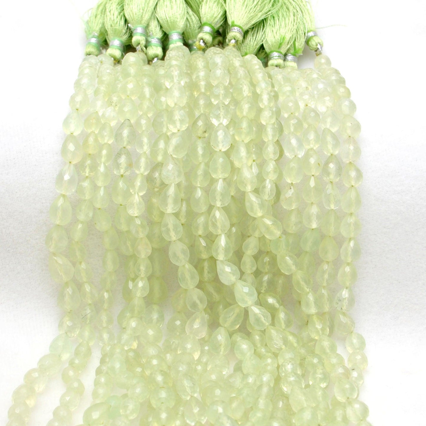 Natural prehnite teardrop beads scattered - inner light glow view
