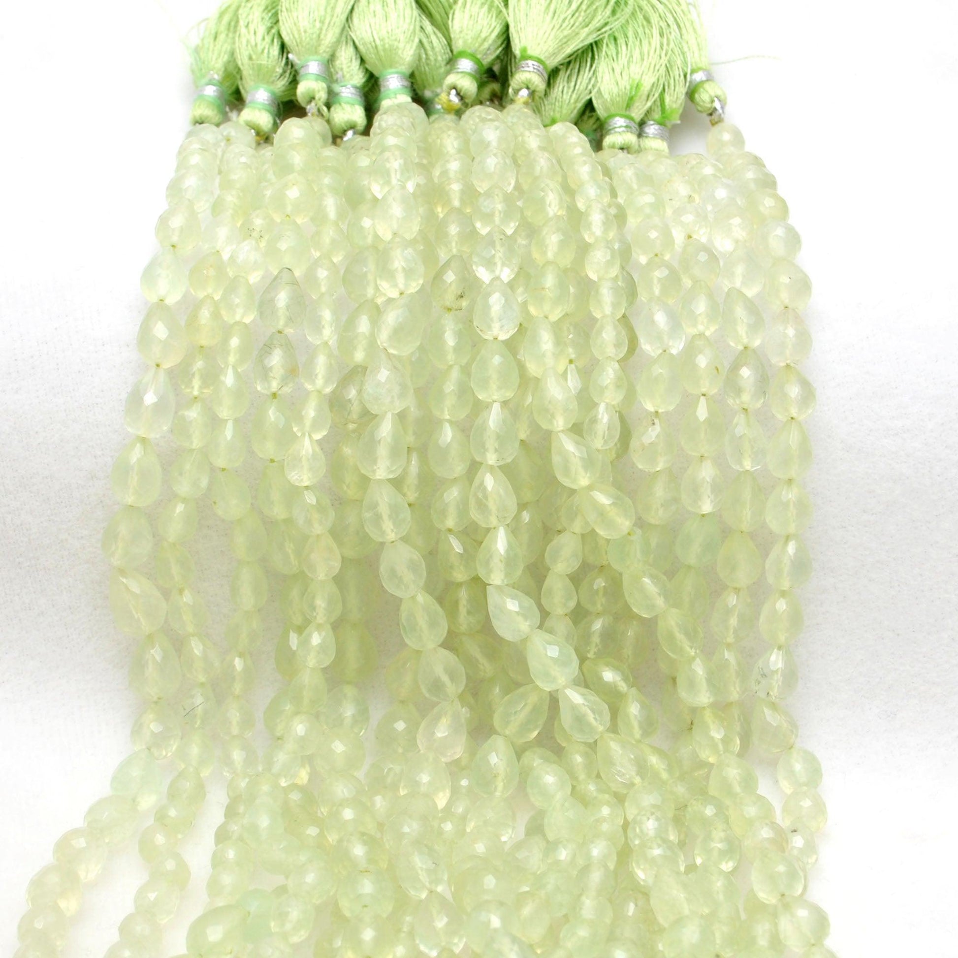 Natural prehnite teardrop beads scattered - inner light glow view