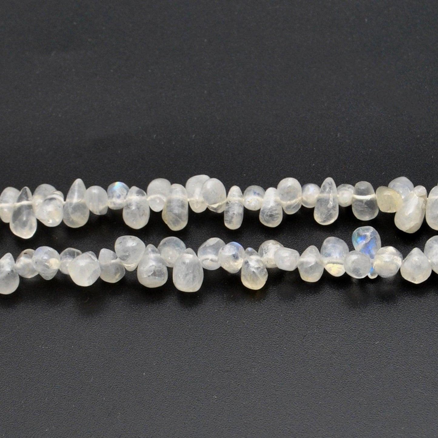 Rainbow moonstone plain drop beads 16 inch strand overhead flat lay