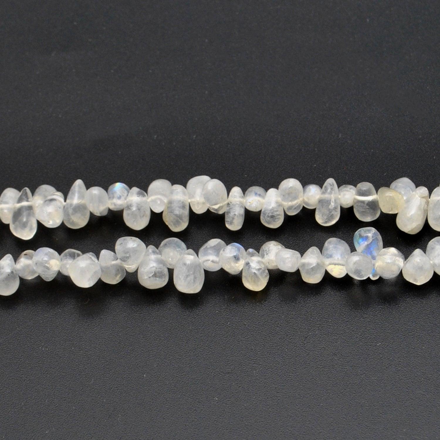 Rainbow moonstone plain drop beads 16 inch strand overhead flat lay